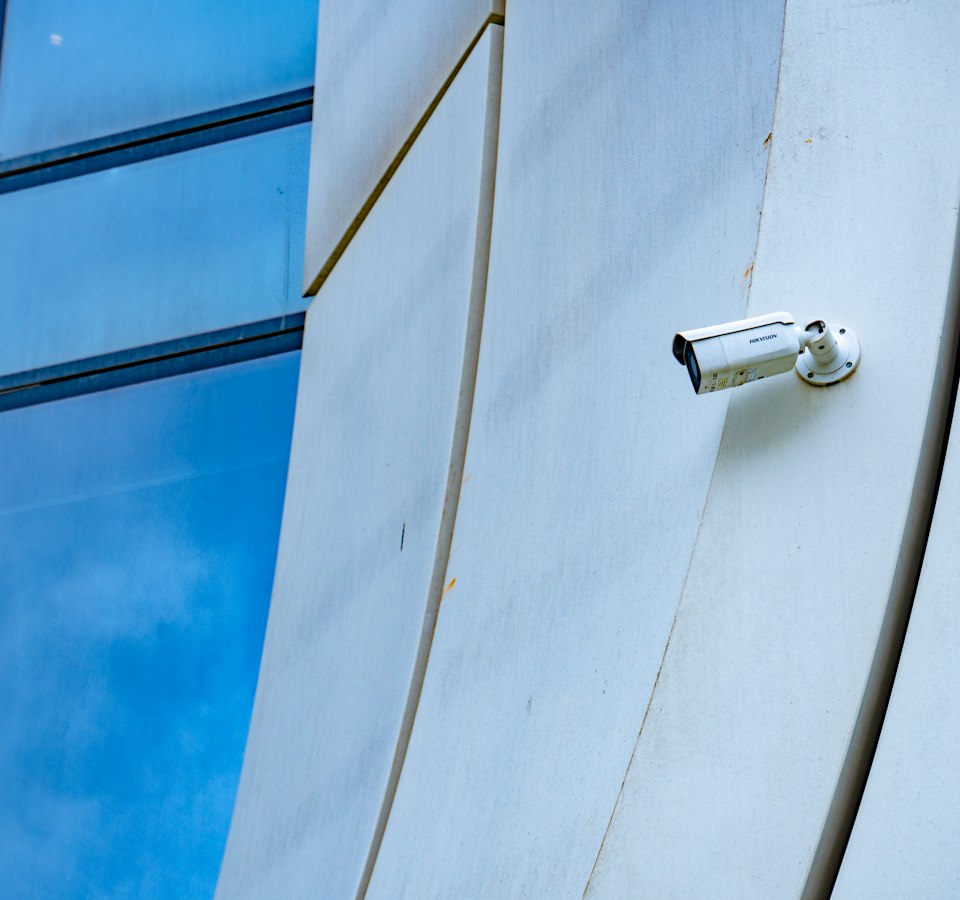 Outdoor CCTV camera mounted on a contemporary commercial building